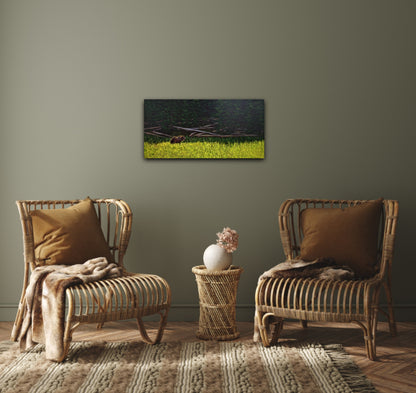 Oil painting of a grizzly bear stepping from a sunlit wildflower meadow into the shadowy calm of a forest, on a green wall behind two chairs