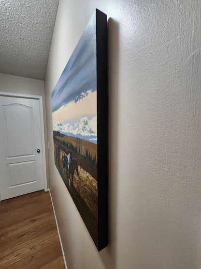 wall with a fall painting of a landscape and horses hanging on it