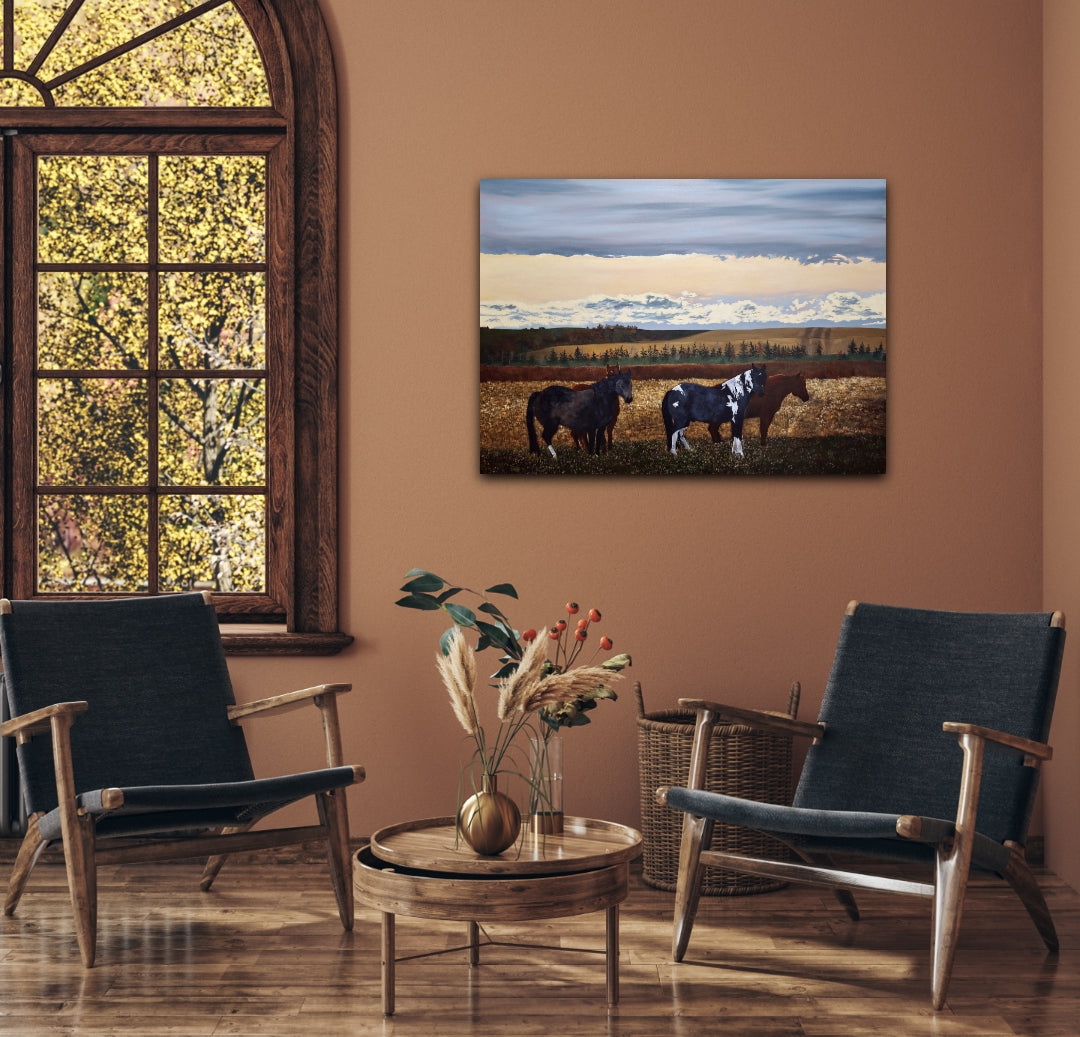 Living room with two dark blue chairs, a wooden coffee table, and a painting of horses on the wall.