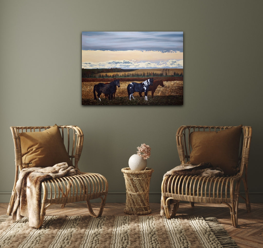 Two wicker chairs with brown cushions in a room with a painting of horses on the wall.