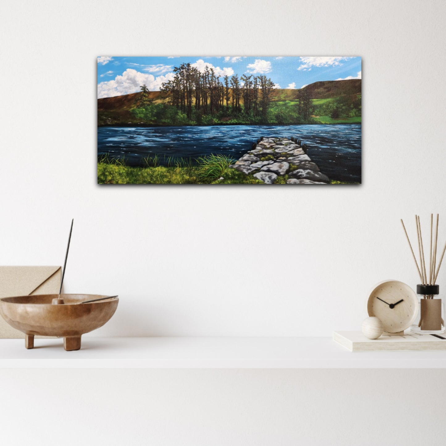 Oil_painting_of_a_stone_dock_leading_to_a_lake_framed_with_large_trees_rolling_hills_grass_and_reeds on a white wall