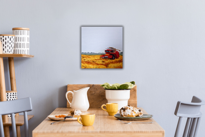 Small breakfast table with coffee and pastries served, overtop hangs a landscape painting of a combine